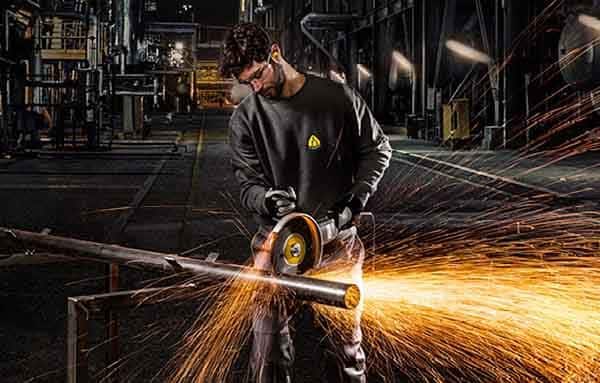Man Grinding the Metal — Building Supplies in Heatherbrae, NSW