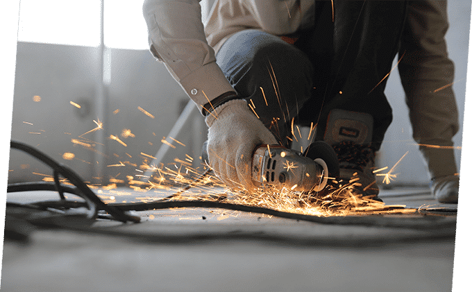 Man Holding Grinder — Building Supplies in Heatherbrae, NSW