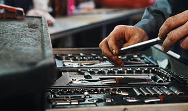 Man Holding Lots of Tools — Building Supplies in Hunter Valley, NSW