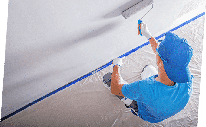Man Paints the Wall with White Colour — Building Supplies in Heatherbrae, NSW