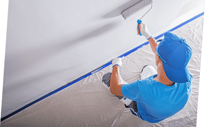Man Paints the Wall with White Colour — Building Supplies in Heatherbrae, NSW