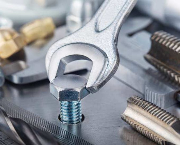 Wrench Tightens Bolt In Steel Billet