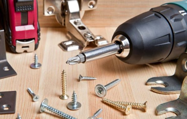 screwdriver with screws on workbench