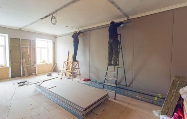 workers installing plasterboard drywall